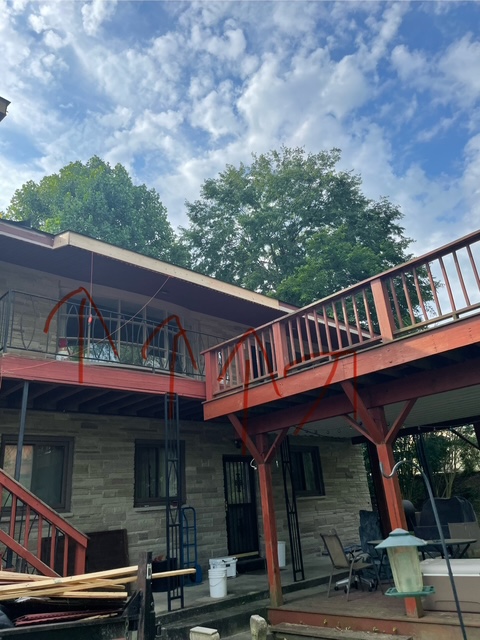 After: completed two-level deck with red stain and full railing