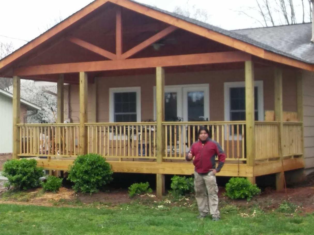 After: finished covered porch with stained gable trusses, posts and railing